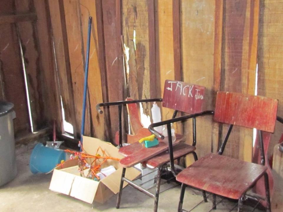 Das poucas cadeiras do barracão-escola, a maioria está quebrada
